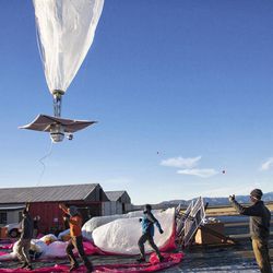 In this June 10, 2013 photo released by Google, a Google team releases a balloon in Tekapo, New Zealand. Google is testing the balloons which sail in the stratosphere and beam the Internet to Earth. 