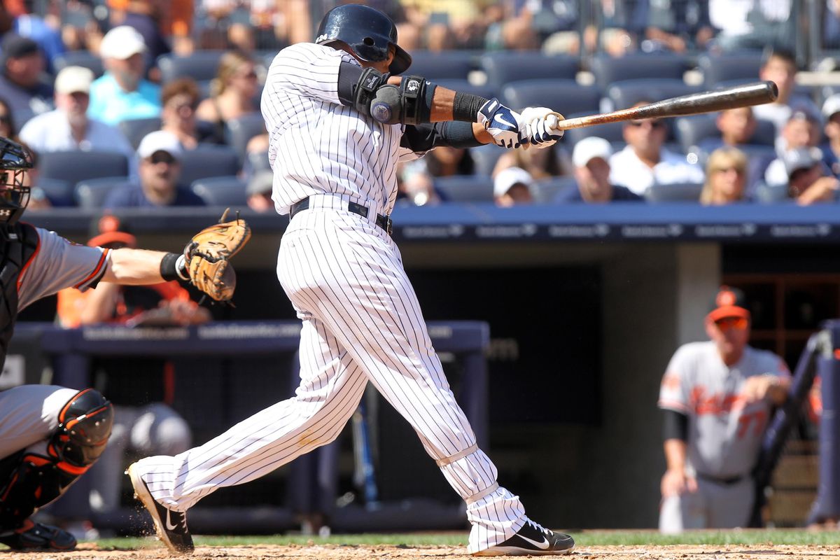 September 1, 2012; Bronx, NY, USA; New York Yankees second baseman Robinson Cano (24) hits a home run during the fourth inning of a game against the Baltimore Orioles at Yankee Stadium. Mandatory Credit: Brad Penner-US PRESSWIRE