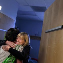 Jose Gallegos, right, greets Lori Bertelsen with a big hug at the hospital in Provo on Friday, June 21, 2013. Bertelsen was visiting Jose's husband, Carl. Bertelsen performed CPR on Gallegos after he went into cardiac arrest last weekend.