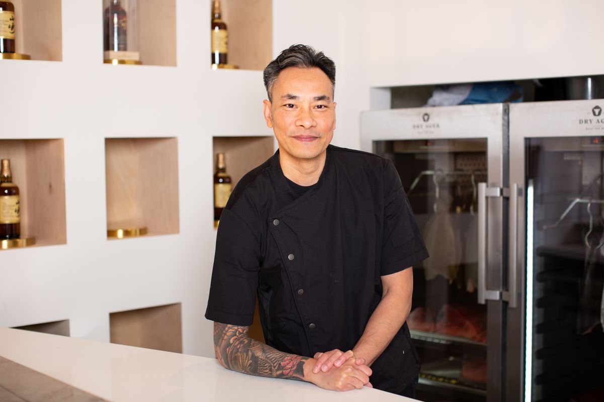 chef Jimmy Kieu in a black uniform, behind a counter at Sushi by Hidden.
