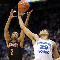 Idaho State Bengals guard Ethan Telfair (3) and Brigham Young Cougars forward Yoeli Childs (23) reach for a rebound during NCAA basketball in Provo on Tuesday, Dec. 20, 2016.