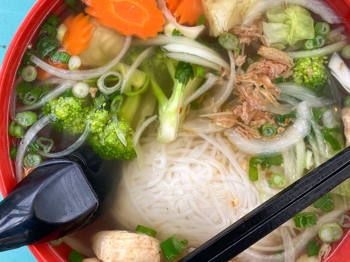 A photo of the vegan pho from Friendship Kitchen, served with a variety of vegetables.