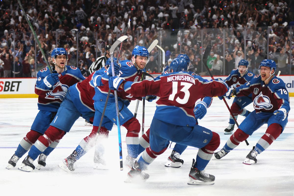 Andre Burakovsky #95 of the Colorado Avalanche celebrates with teammates after scoring a goal against Andrei Vasilevskiy #88 of the Tampa Bay Lightning during overtime to win Game One of the 2022 Stanley Cup Final 4-3 at Ball Arena on June 15, 2022 in Denver, Colorado.