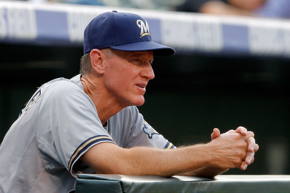 DENVER, CO - AUGUST 14:  Manager Ron Roenicke #10 of the Milwaukee Brewers looks on from the dugout against the Colorado Rockies at Coors Field on August 14, 2012 in Denver, Colorado.  (Photo by Doug Pensinger/Getty Images)