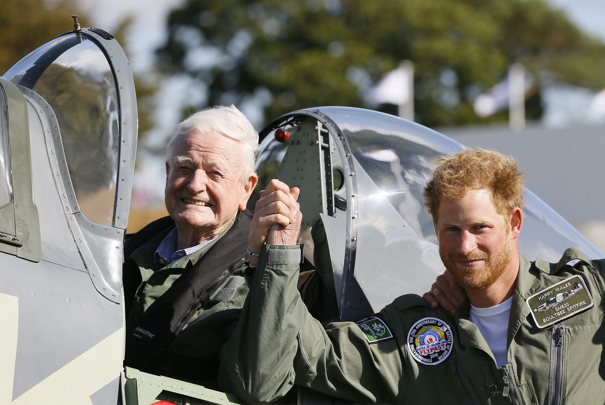 Prince Harry holds hands with 95 year old Battle of Britain Veteran Tom Neil after he landed back at Goodwood Aerodrome in his Spitfire after a Battle of Britain Flypast at Goodwood on September 15, 2015 in Chichester, England. The 75th Anniversary of the Battle of Britain is being marked by a historic flypast that brings more Battle of Britain aircraft together than ever before as a show of thanks to 'the few' and the sacrifices they made. (Photo by Chris Jackson/Getty Images)