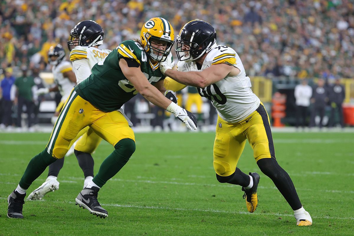 T.J. Watt #90 of the Pittsburgh Steelers is blocked by Robert Tonyan #85 of the Green Bay Packers during a game at Lambeau Field on October 03, 2021 in Green Bay, Wisconsin.