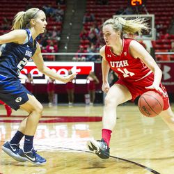 Utah guard Paige Crozon (14) drives against Brigham Young guard Makenzi Pulsipher (23) during an NCAA women's college basketball game in Salt Lake City on Saturday, Dec. 10, 2016. Utah defeated rival Brigham Young 77-60.