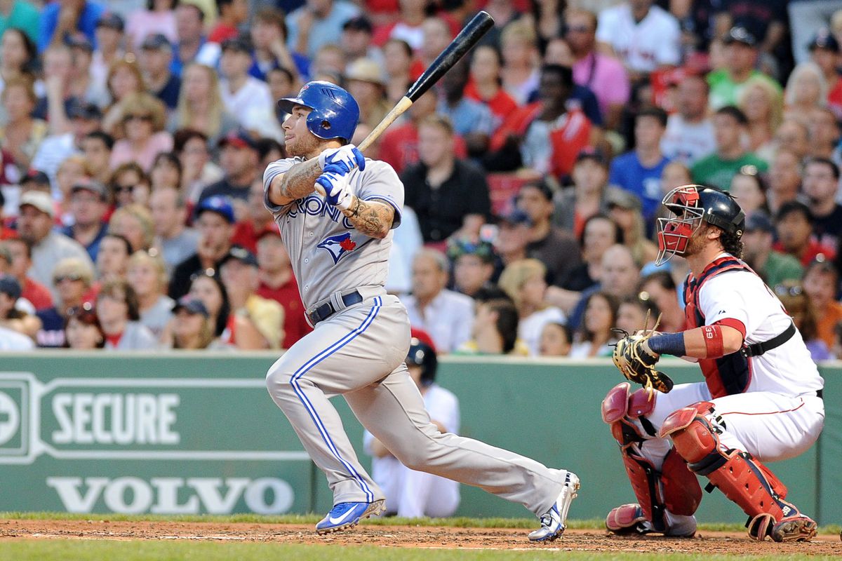 July 21, 2012; Boston, MA, USA; Toronto Blue Jays third baseman Brett Lawrie (13) hits a sacrifice fly during the third inning against the Boston Red Sox at Fenway Park. Mandatory Credit: Bob DeChiara-US PRESSWIRE