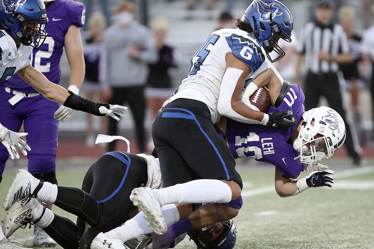 Pleasant Grove’s Isaac Vaha tackles Lehi’s Chandler Jenkins during a football game at Lehi High School in Lehi on Friday, Sept. 11, 2020.