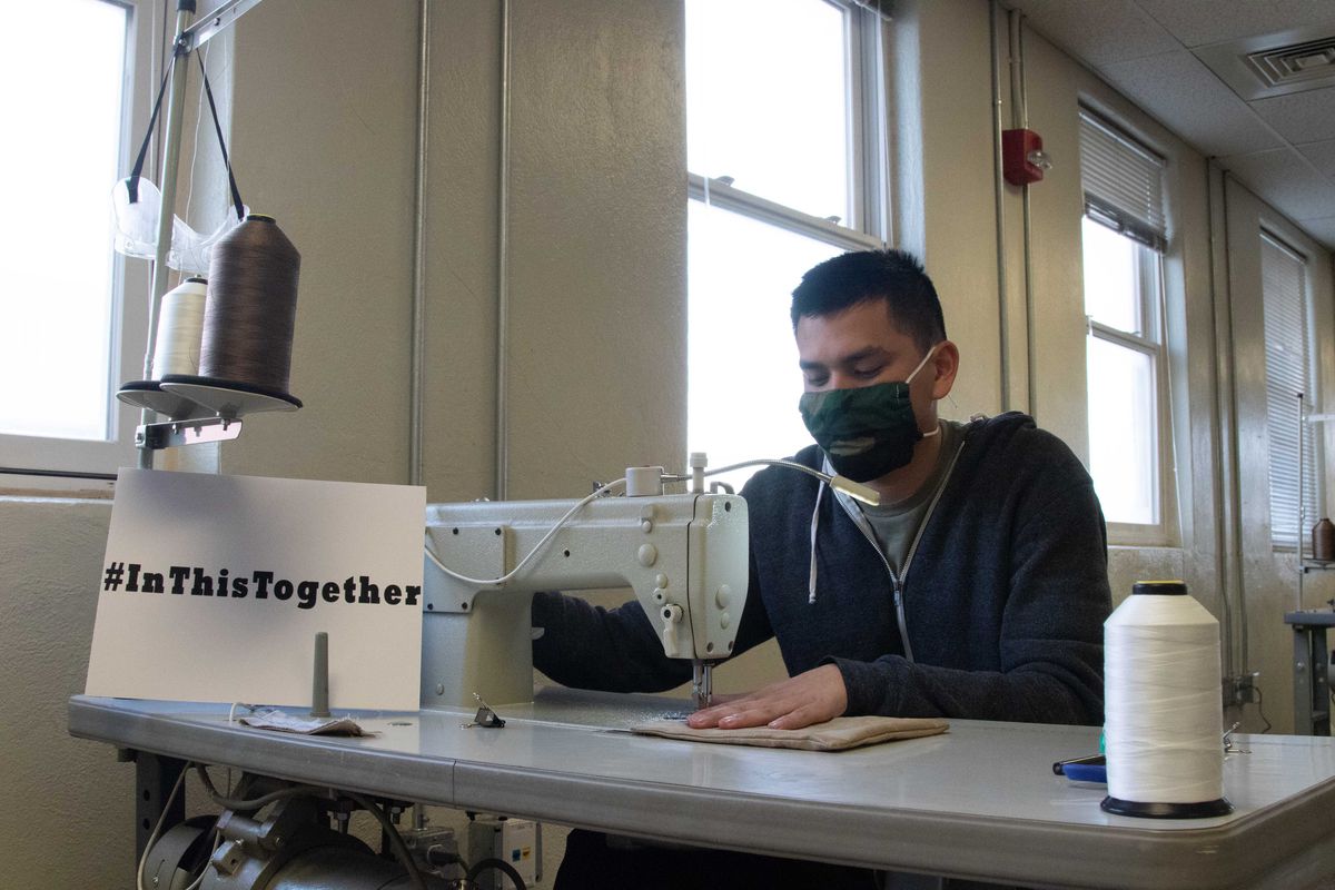 Spc. Kalani Bedell, a parachute rigger from the 19th Special Forces Group, sews together two layers of fabric to make masks to protect Utah National Guard soldiers.