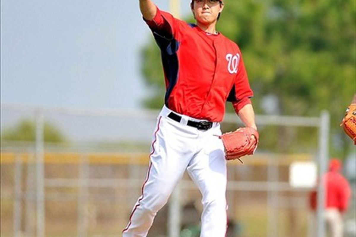 February 23, 2012; Melbourne, FL, USA;  Washington Nationals starting  pitcher Chien-Ming Wang (40) throws to first during fielding drills at Space Coast Stadium. Mandatory Credit: Brad Barr-US PRESSWIRE
