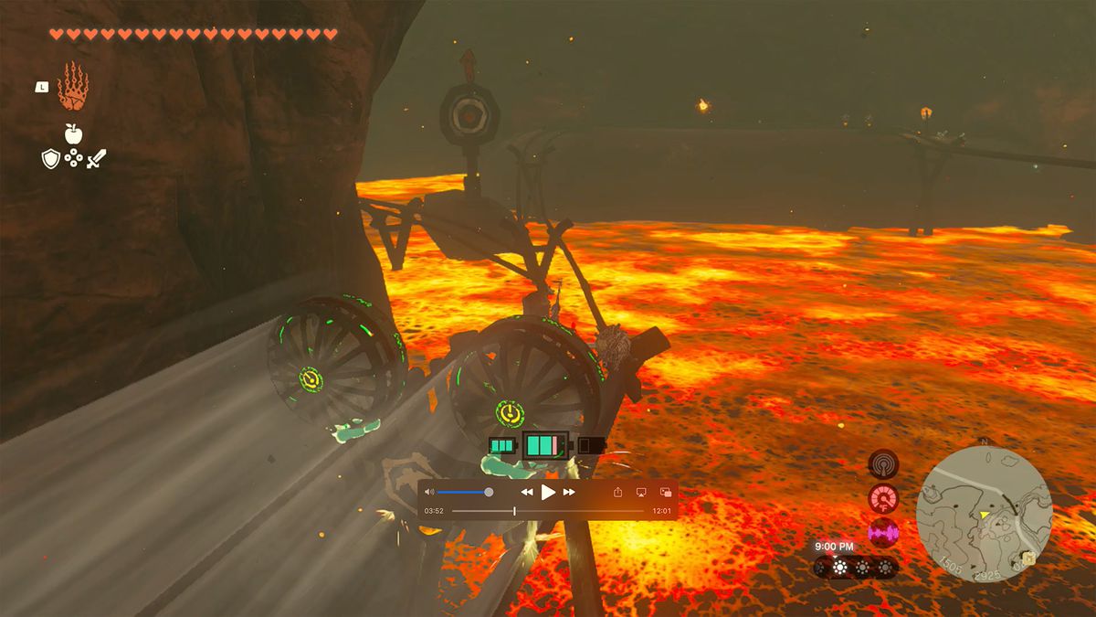 Link rides on a minecart through a lava-filled cave in a screenshot from The Legend of Zelda: Tears of the Kingdom