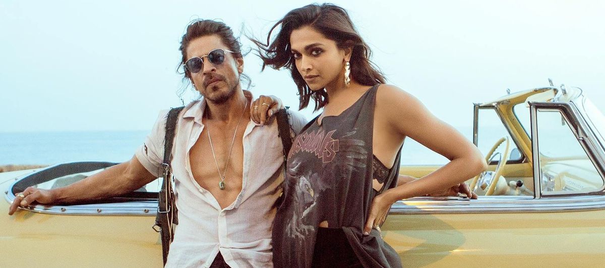 Shah Rukh Khan and Deepika Padukone lean against a yellow convertible while looking mind-bogglingly hot in Pathaan. They look like they saw you from across the bar and liked your vibe.