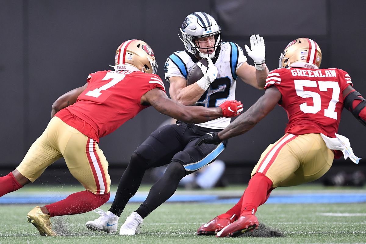 Christian McCaffrey #22 of the Carolina Panthers is tackled by the 49ers