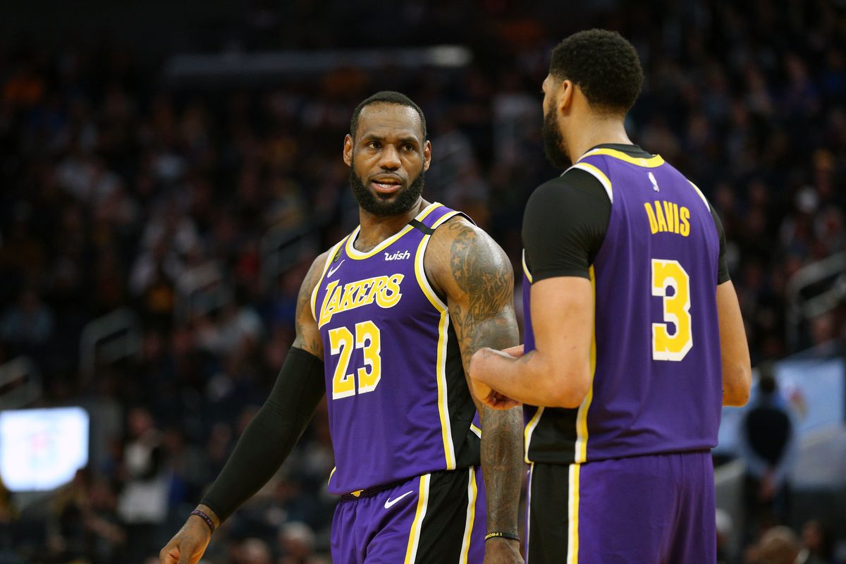 Los Angeles Lakers forward LeBron James talks with center Anthony Davis during a break in the action against the Golden State Warriors in the fourth quarter at the Chase Center.