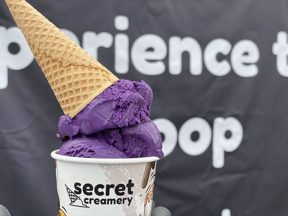 Ube ice cream in a cup with a cone on top