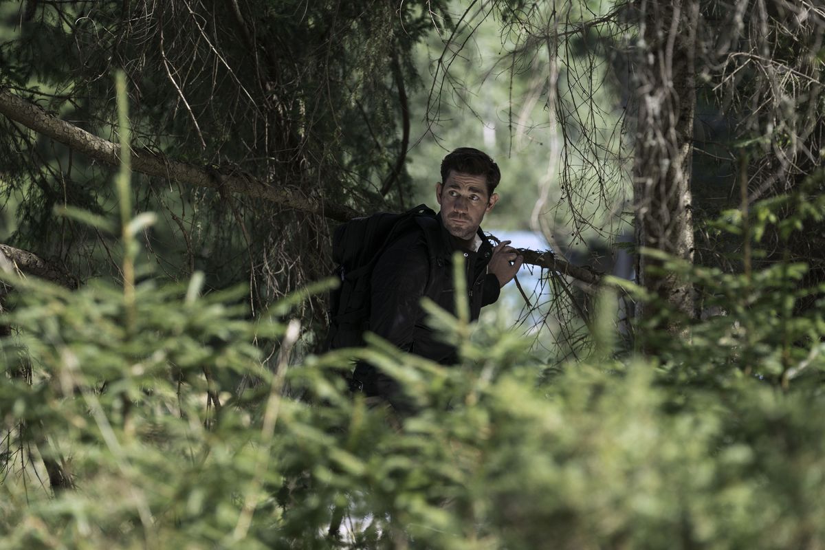 Jack Ryan (John Krasinski) hiding in a tree