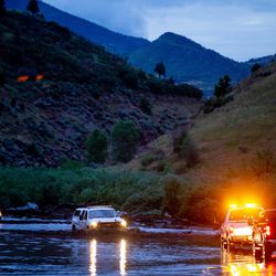 Officials respond to flooding on U.S. 89 near Thistle, in southeast Utah County, on Friday, July 26, 2019. Utah Highway Patrol said 30 cars were stranded on the road due to flooding caused by heavy rain, but all people were accounted for and no injuries reported.