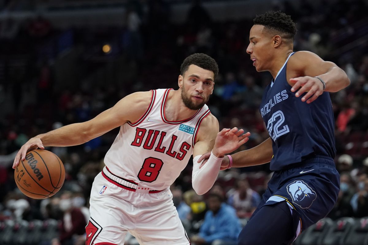 Zach LaVine #8 of the Chicago Bulls dribbles the ball against Desmond Bane #22 of the Memphis Grizzlies in the first half during a preseason game at United Center on October 15, 2021 in Chicago, Illinois.