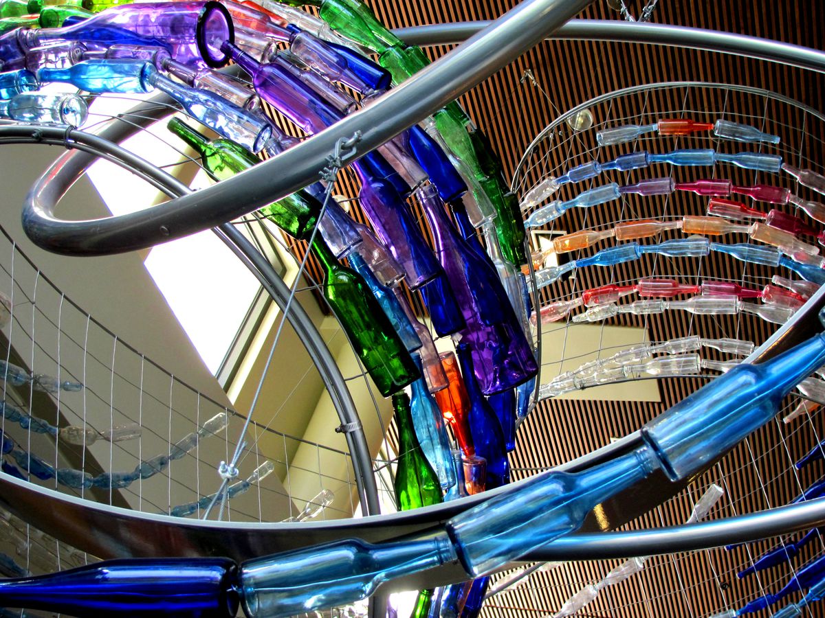 The interior of the Walnut Creek Library Contra Costa County Library in California. There are multiple colorful curved structures going up to the ceiling. 