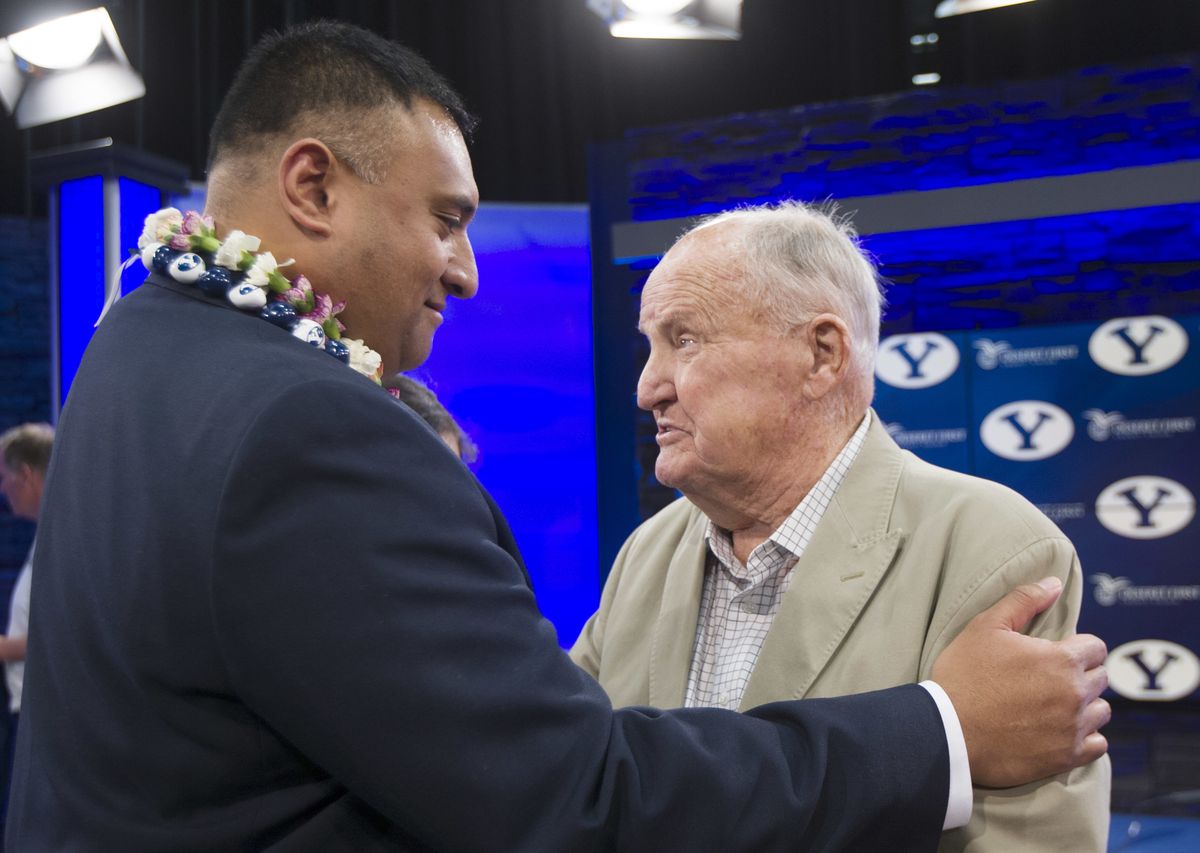 BYU's new head football coach Kalani Sitake talks briefly with former head coach LaVell Edwards, following a press conference in Provo, Utah, Monday, Dec. 21, 2015. Sitake played for Edwards during his career.