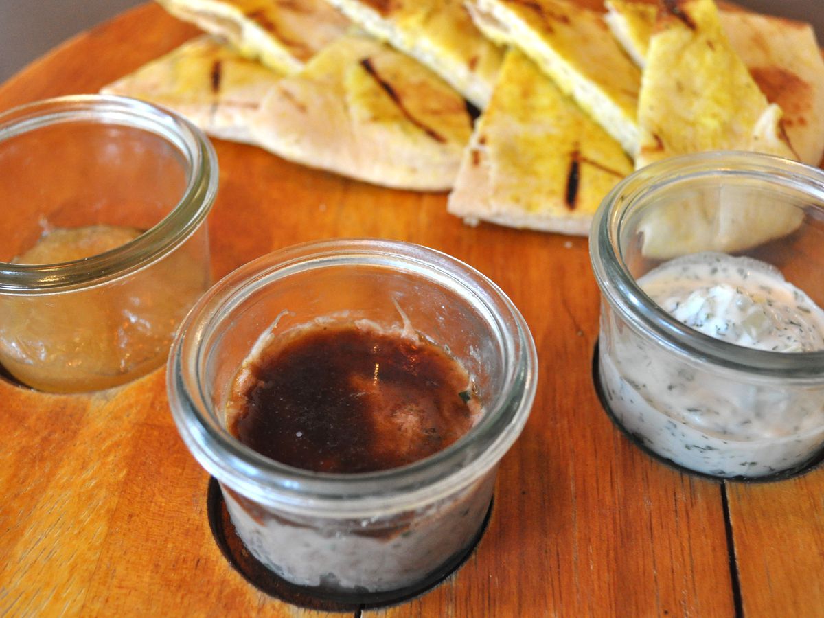 Jars of rillettes and other spreads with pita