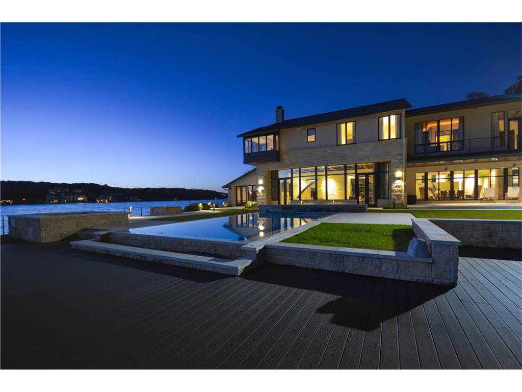 Large contemporary home on lake at dusk