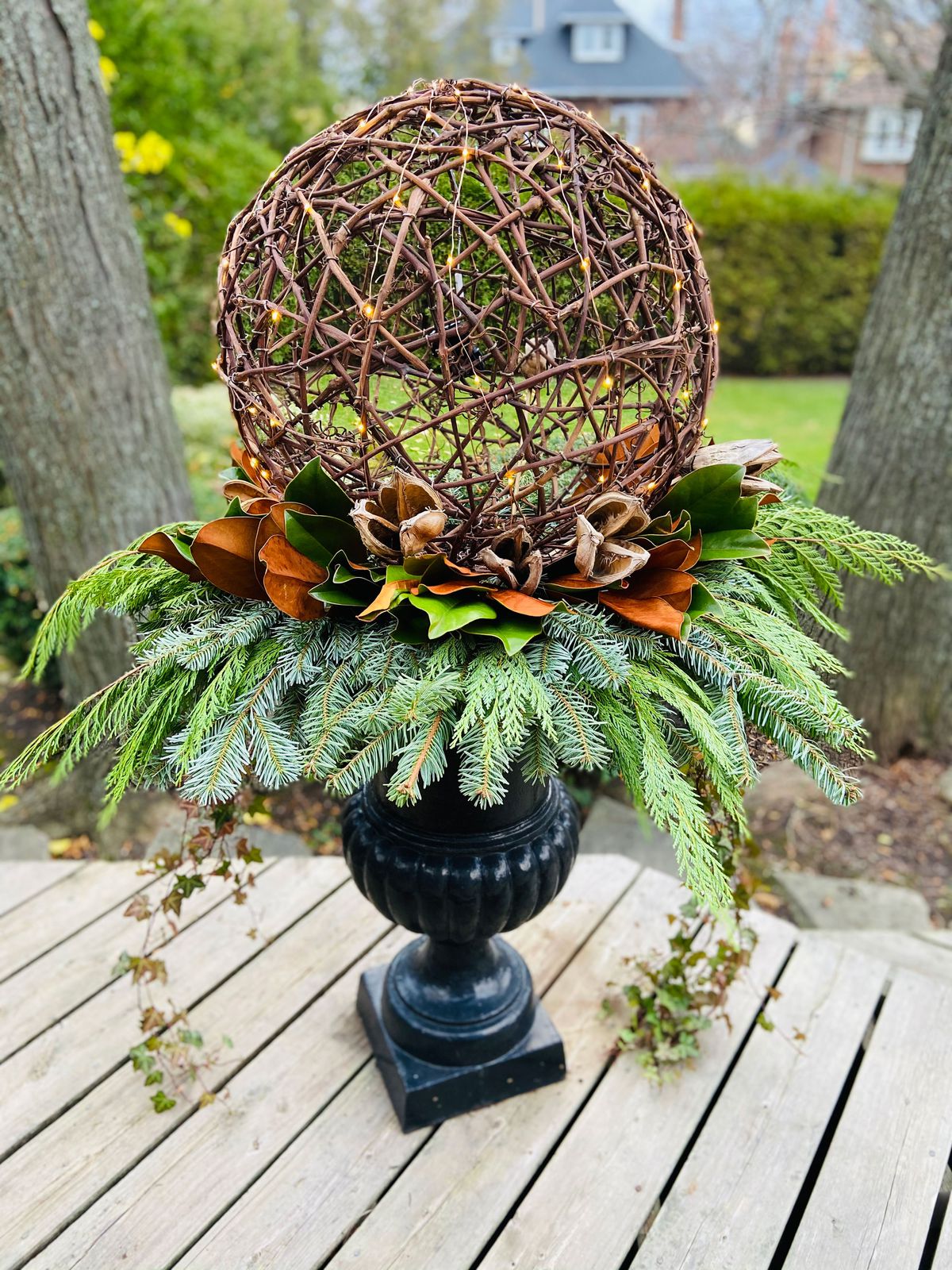 A winter topiary with a grape vine ball on top.