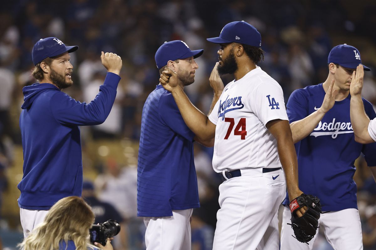 Kenley Jansen of the Los Angeles Dodgers celebrates with Clayton Kershaw, Max Scherzer and Walker Buehler after defeating the Pittsburgh Pirates 4-3 during the ninth inning at Dodger Stadium on August 17, 2021 in Los Angeles, California.