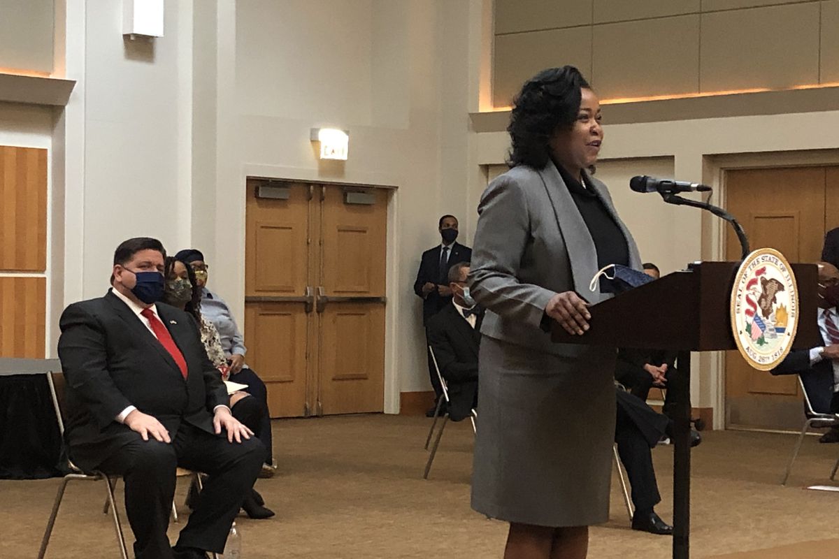 Democratic state Rep. Sonia Harper speaks at a press conference about the Illinois Legislative Black Caucus’s agenda. To the left, Gov. J.B. Pritzker sits in a chair while listening.