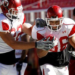 Sausan Shakerin, left, and Eddie Wide run through a play during a University of Utah football practice at Rice-Eccles Stadium on Wednesday.