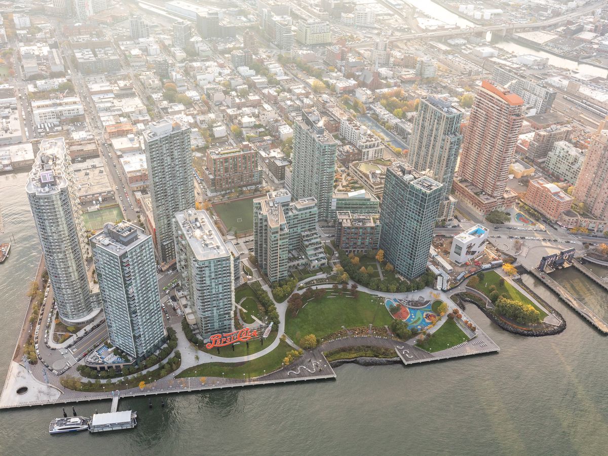 An aerial view of many city buildings along a waterfront.