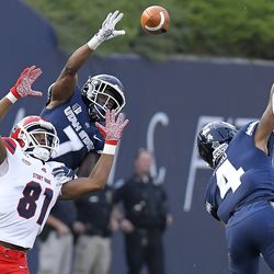 Utah State cornerback DJ Williams (7) and safety Shaq Bond break up a pass intended for Stony Brook wide receiver Delante Hellams Jr. (81) during an NCAA college football game, Saturday, Sept. 7, 2019, in Logan, Utah. 