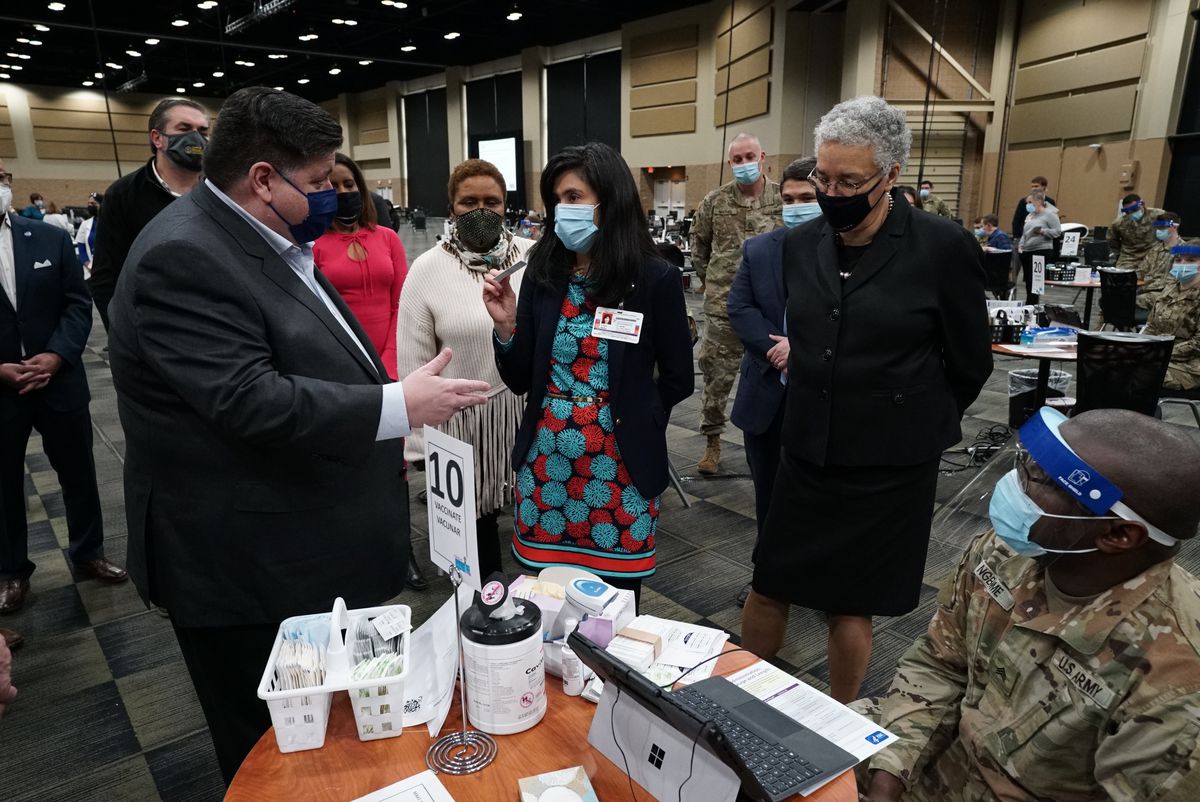 Cook County Board President Toni Preckwinkle and Gov. J.B. Pritzker take a tour of the first large-scale community vaccination site in suburban Cook County as it prepares to open in the Tinley Park Convention Center.