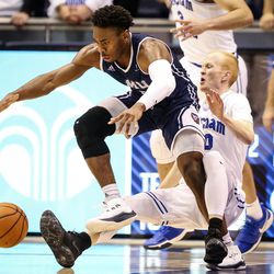 Loyola Marymount Lions guard James Batemon (5) looses the ball as he knocks Brigham Young Cougars guard TJ Haws (30) to the floor for a called charge as the Brigham Young Cougars take on the Loyola Marymount Lions at the Marriott Center in Provo on Thursday, Jan. 18, 2018.