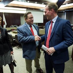 Draper Councilwoman Marsha Vawdrey, left, watches as Draper Mayor Troy K. Walker and Salt Lake County Mayor Ben McAdams shake hands after announcing Draper has volunteered two possible sites to locate a new homeless resource center. The announcement was made during a press conference at the Salt Lake County Government Center in Salt Lake City on Tuesday, March 28, 2017.