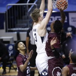 BYU center Matt Haarms (3) dunks the ball as he’s surrounded by a trio of Texas Southern defenders during the Cougars’ 87-71 victory at the Marriott Center in Provo on Monday, Dec. 21, 2020.