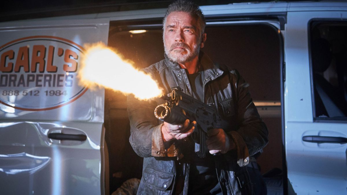 Arnold Schwarzenegger bearded T-800 Terminator unloads an automatic weapon at a target offscreen
