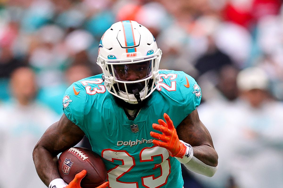 Jeff Wilson Jr. #23 of the Miami Dolphins carries the ball against the Green Bay Packers during the first half of the game at Hard Rock Stadium on December 25, 2022 in Miami Gardens, Florida.