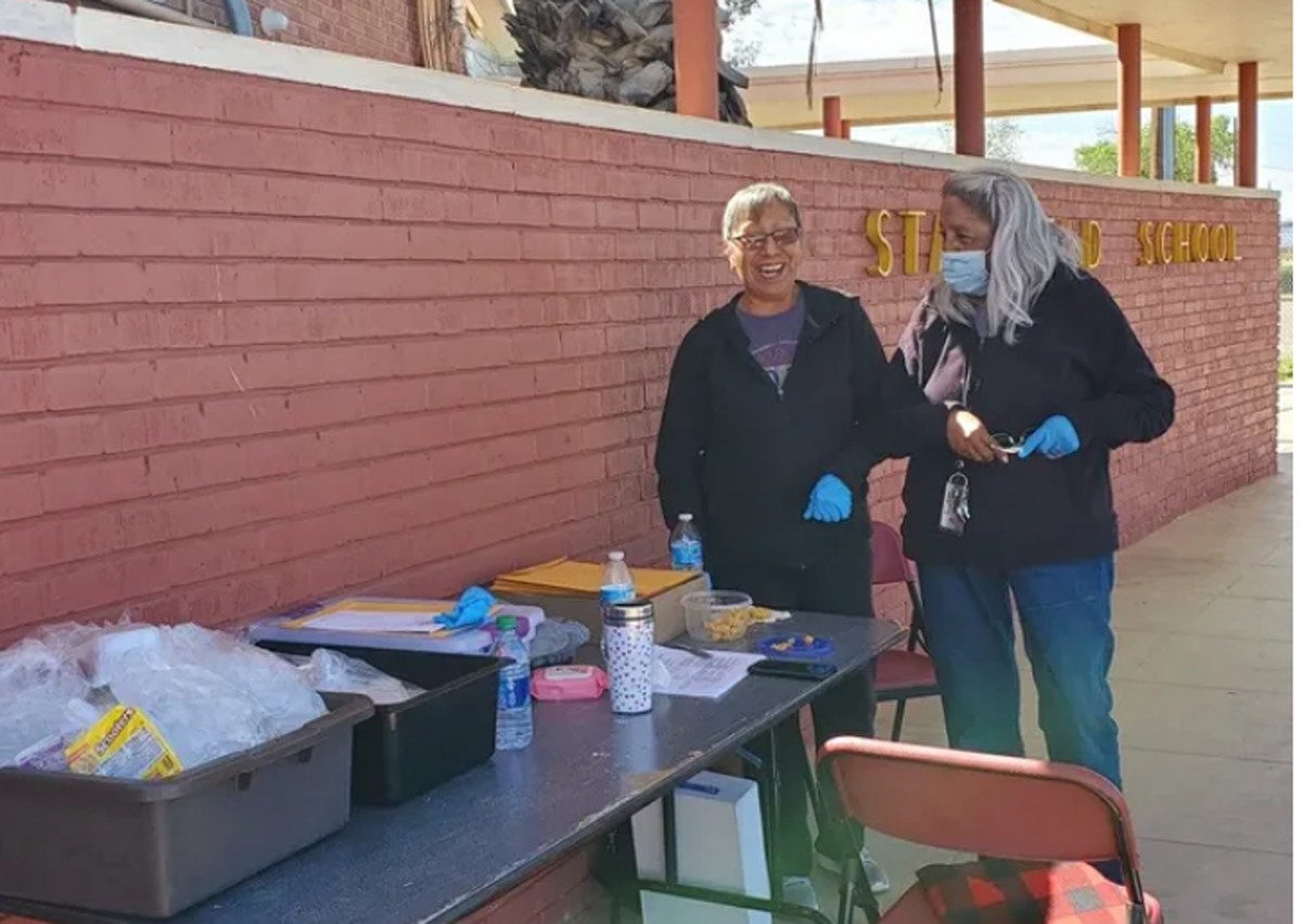 Rose Gamez (left), a paraprofessional with the Stanfield school district, and kindergarten teacher Maria Garcia helped feed children in their Arizona district over the summer.