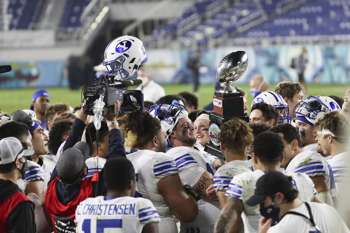 BYU Cougars react as they hoist the trophy after winning the Boca Raton Bowl in Boca Raton, Fla., on Tuesday, Dec. 22, 2020.