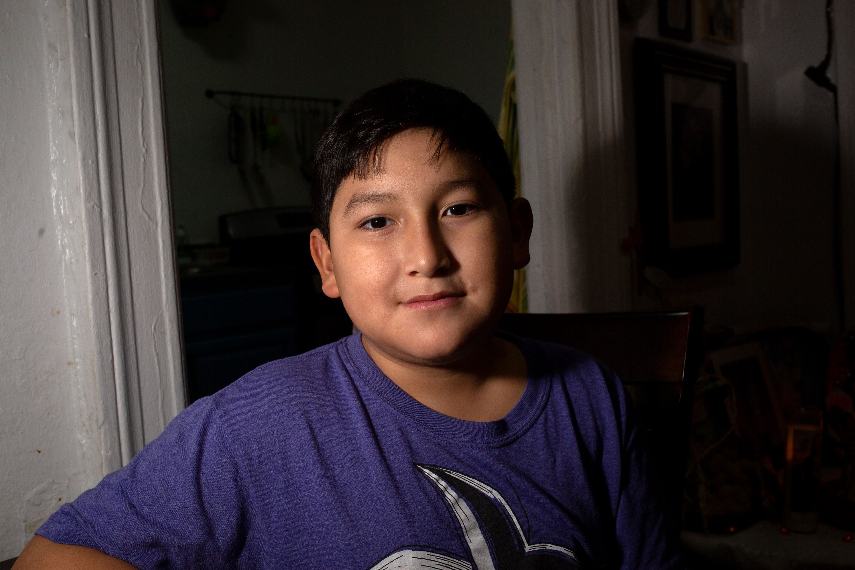 10-year-old Washington Heights resident Alejandro Amaya sits in the dining area of his late uncle’s Washington Heights apartment.