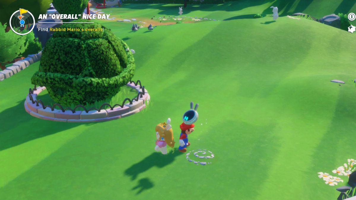 Mario and Rabbid Peach stand around a coin swirl in the Mushroom Kingdom into in Mario + Rabbids Sparks of Hope