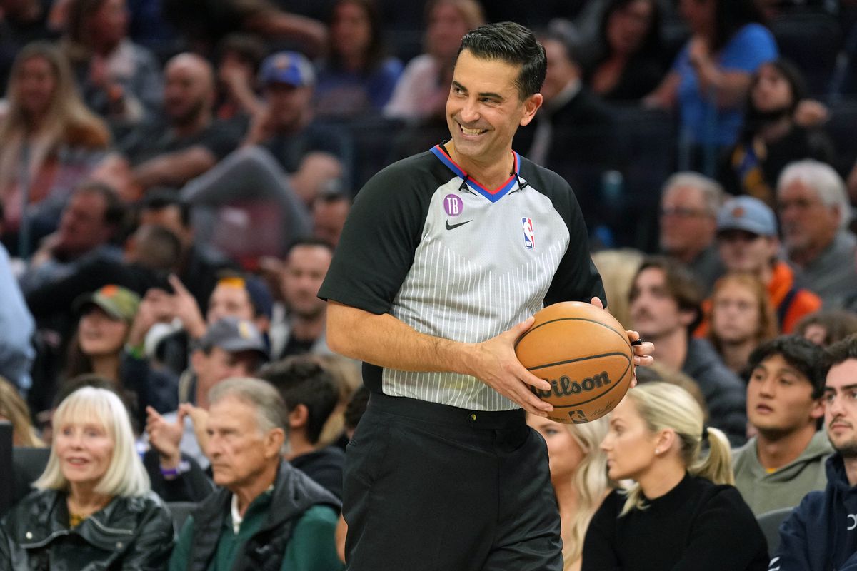 NBA referee Zach Zarba (15) holds the ball during the fourth quarter of the game between the Golden State Warriors and the Utah Jazz at Chase Center.