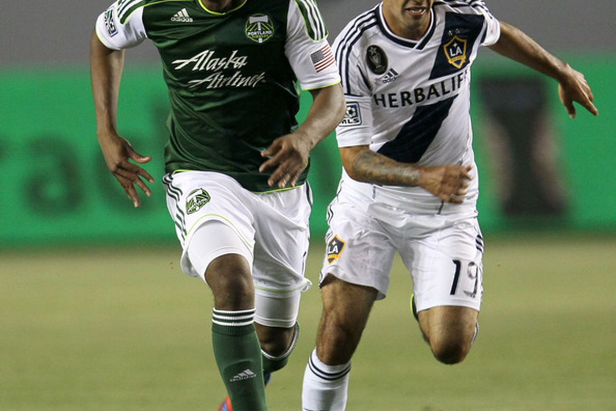 CARSON, CA - APRIL 14:   Darlington Nagbe #6 of the Portland Timbers runs witht he ball ahead of Juninho #19 of the Los Angeles Galaxy at The Home Depot Center on April 14, 2012 in Carson, California.  (Photo by Stephen Dunn/Getty Images)