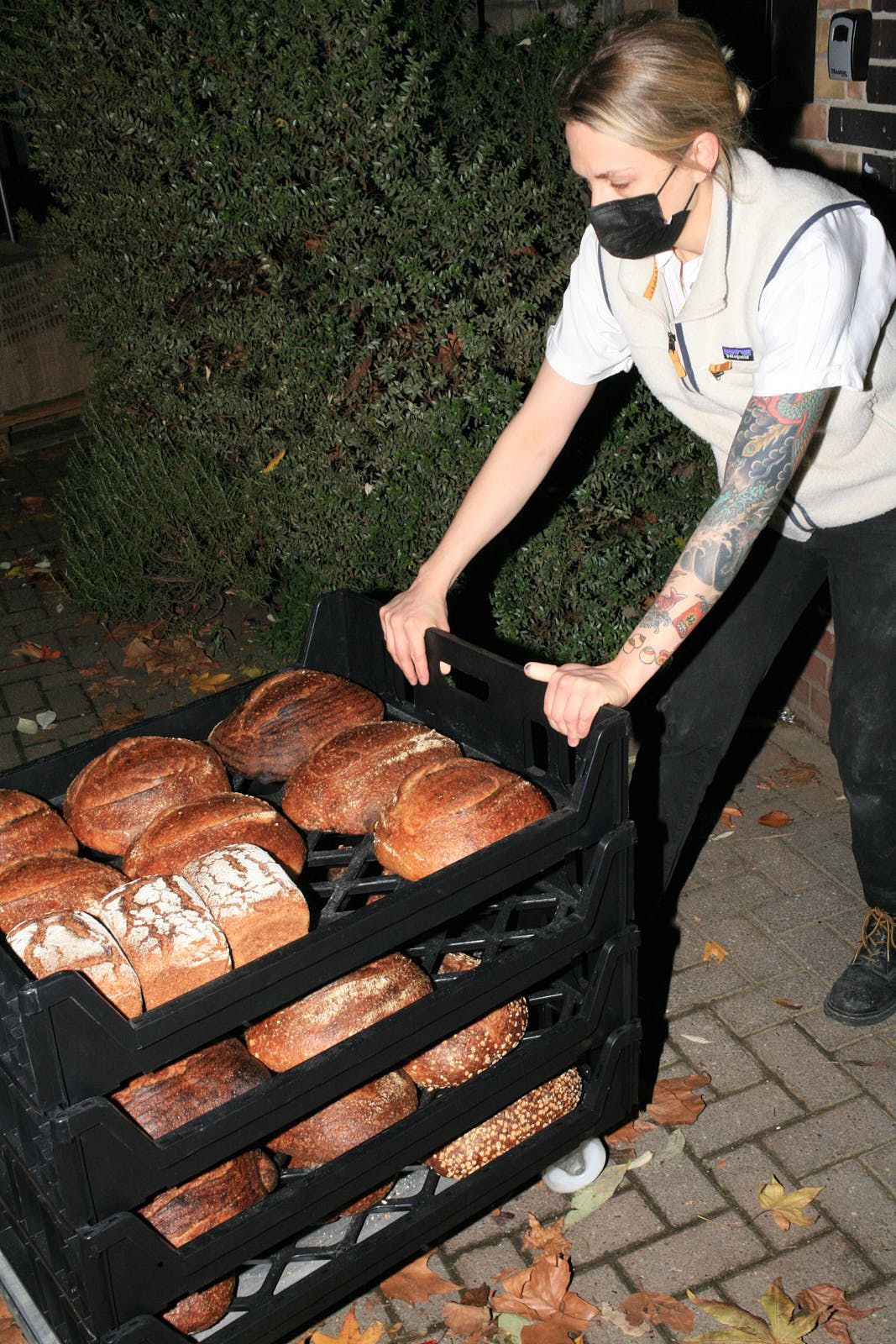 Evans stands over crates of bread outside the bakery