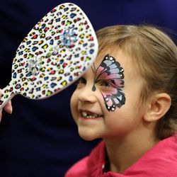 Chloe Nay gets her face painted at Make-A-Wish Utah's annual Easter egg hunt for children facing life-threatening medical conditions at the Discovery Gateway Museum in Salt Lake City on Saturday, March 19, 2016. 