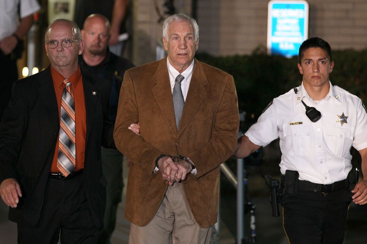 Jerry Sandusky leaves court in handcuffs after a Centre County jury found him guilty on 45 of 48 counts of sexual abuse. (Mark Wilson/Getty Images)