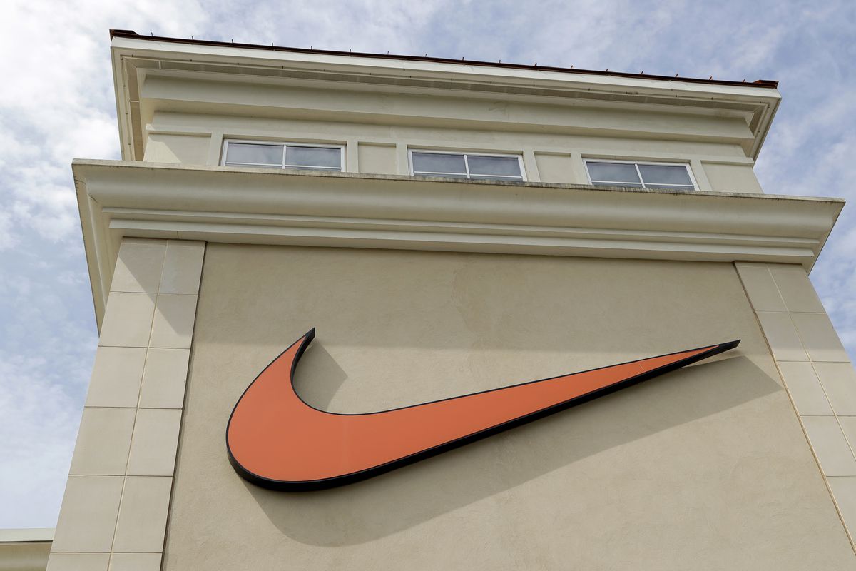 In this file photo dated Tuesday, Sept. 4, 2018, a Nike company logo is displayed outside a Nike store in Charlotte, N.C. The company is under fire from some who think one of its shoe logos is offensive to Muslims.