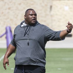 Coach Zarnell Fitch instructs the defensive line during a drill.